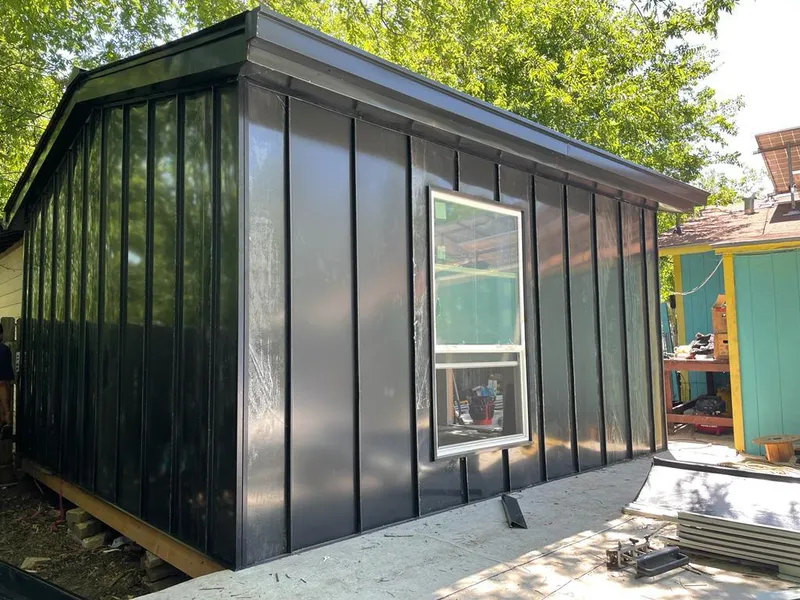 Black standing seam metal wall panels for Roof Inspection in Coffeyville